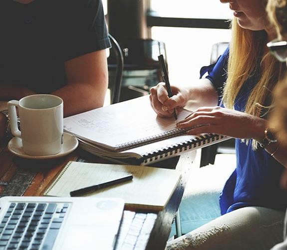close up of person going to write in a notebook