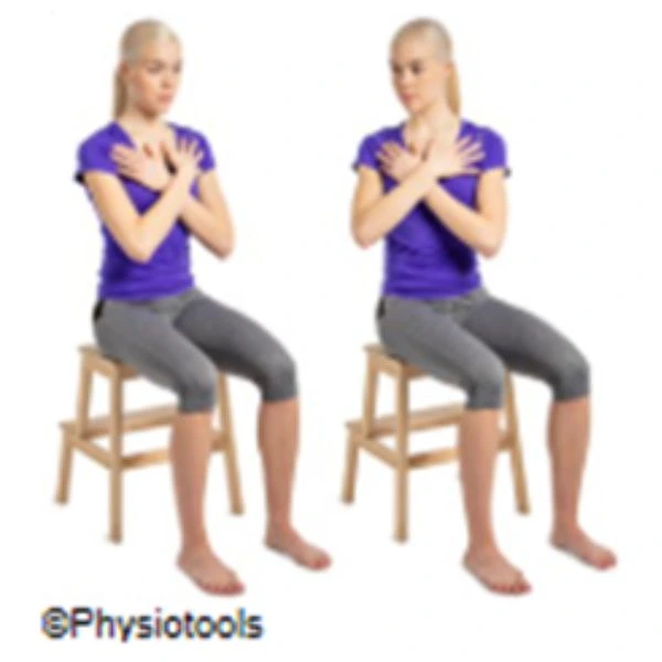 two people demonstarting a seated trunk rotation exercise